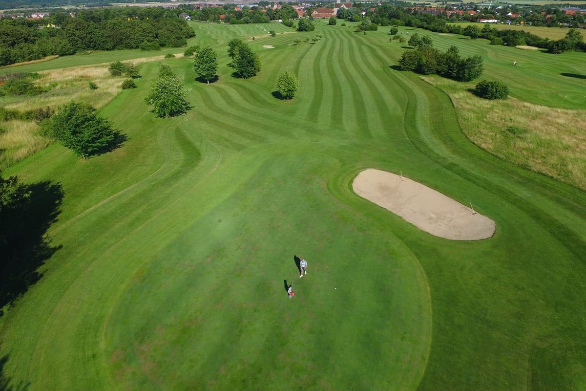 Luftaufnahme einer Spielbahn mit Bunker und zwei Golfern im Golf- und Land-Club St. Lorenz